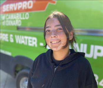 Portrait of Juliana, female employee in front of green truck